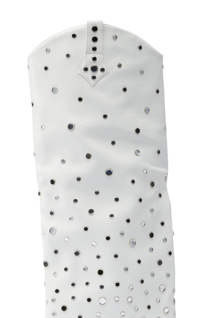 A close-up of the AZALEA WANG MADLOCK WHITE EMBELLISHED WESTERN BOOT, featuring white leather, a curved top edge with a small tab and three black studs, plus round silver and black studs for bold Rhinestone Cowgirl style.