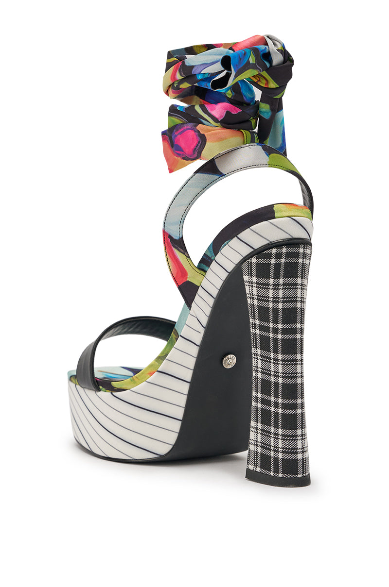 The AKIRA GOLD MAGRITTE MULTI STRIPE PRINT CHUNKY PLATFORM SANDAL features a high heel, striped sole, plaid-covered chunky heel, and colorful abstract-print fabric ankle-wrap straps. 5
