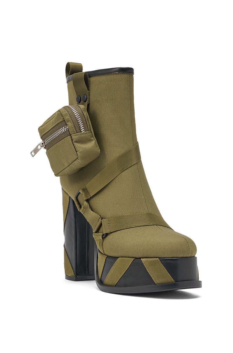 The AZALEA WANG MAHOMES OLIVE SPORTY COMBAT BLOCK BOOTIE features olive green chunky heels, black accents, a thick platform, side mini zippered pouch, decorative straps, and a modern street-style utilitarian design. 4