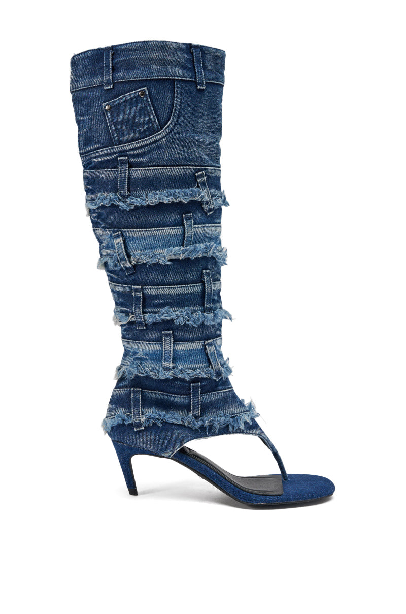 The AKIRA GOLD MAHONEY DENIM PANT DETAIL GLADIATOR STILETTO is a knee-high sandal with a denim upper styled like distressed jeans, featuring frayed edges, belt loops, pockets, and a toe thong. 4