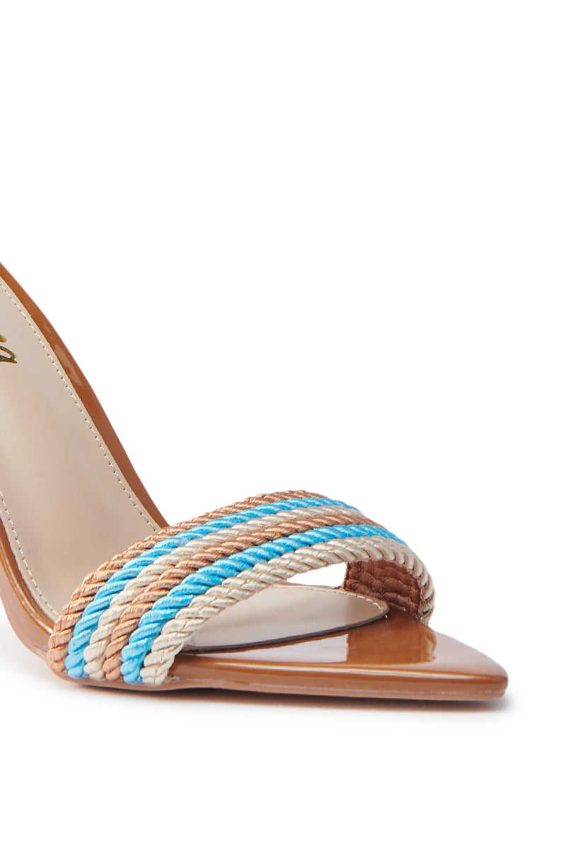 Close-up of the MANSON BROWN ROPE STIELTTO WRAP UP SANDAL: a women's pointed-toe sandal with a tan sole and three braided straps in tan, white, and blue faux patent leather. The minimalist design is enhanced by contrasting colors for a chic look.