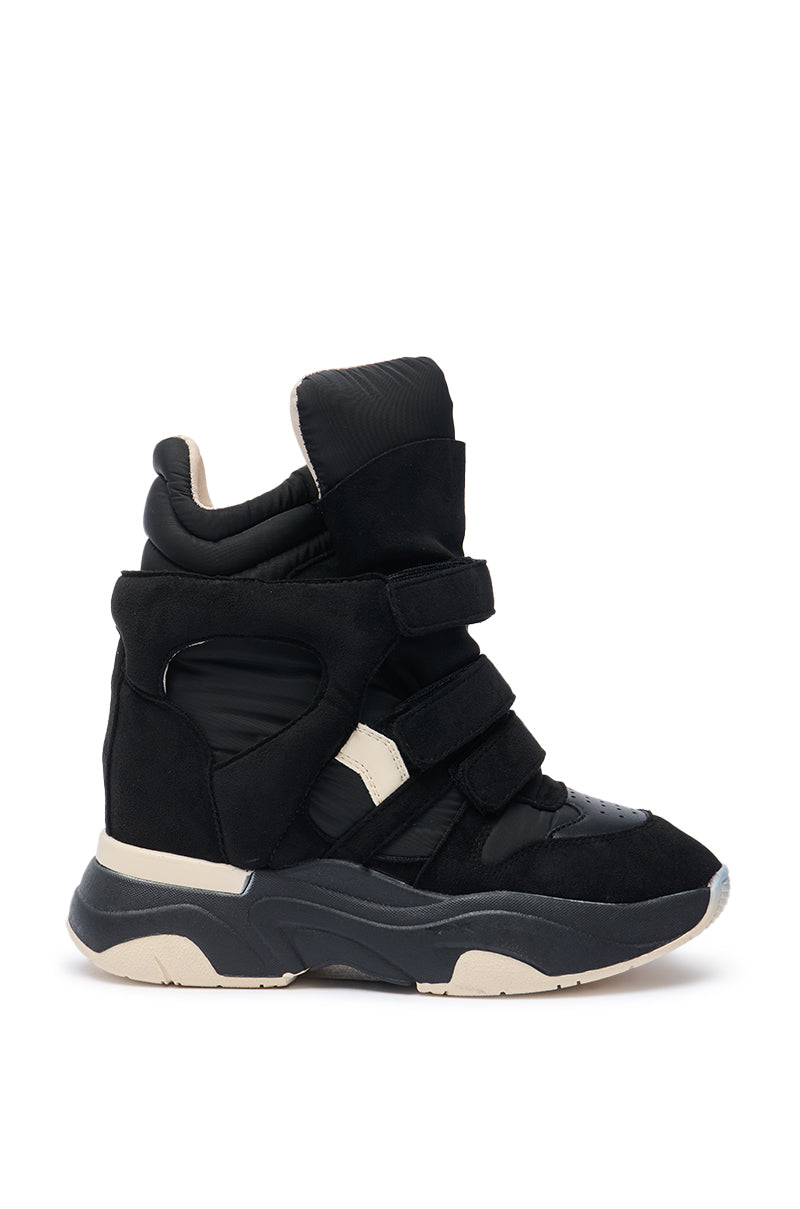 The MARANTO CHUNKY BLACK SNEAKER is a black high-top with three velcro straps, beige accents, a padded ankle collar, a thick cushioned sole, and a concealed wedge heel for extra height, shown against a white background.
