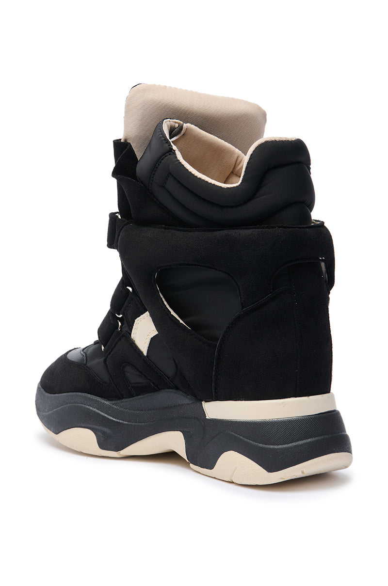 The MARANTO CHUNKY BLACK SNEAKER is a bold high-top with a chunky, layered sole, black cut-out details, and beige accents on the collar and sole—seen from the back/side for standout style.