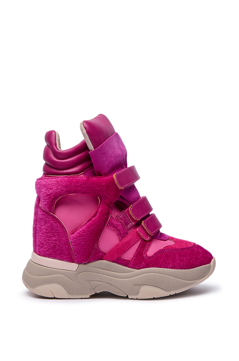 The MARANTO FUCHSIA COLOR BLOCKED WEDGE SNEAKER features a vibrant pink hue, velcro straps, suede and mesh panels, color-block design, and a thick beige sole, displayed against a white background.