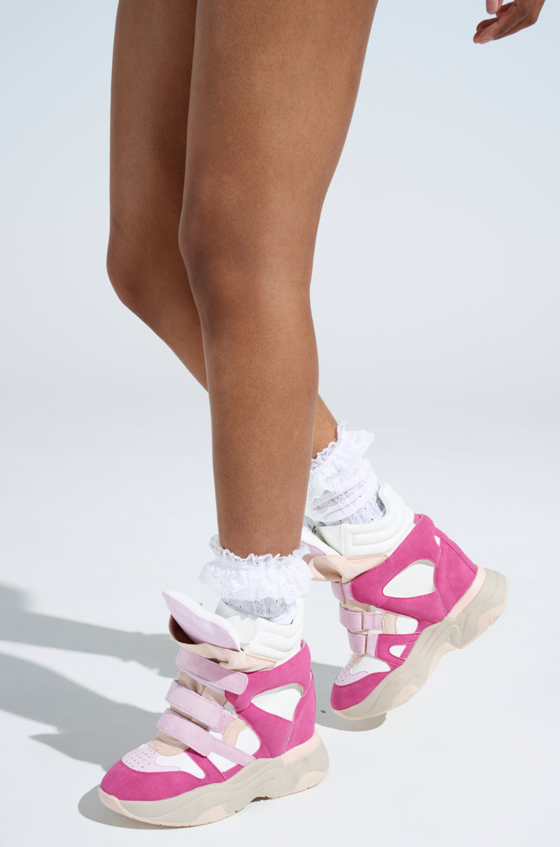 A person is wearing MARANTO Chunky Pink Wedge Heel Sneakers with white lace-trimmed socks against a light background, highlighting their lower legs.