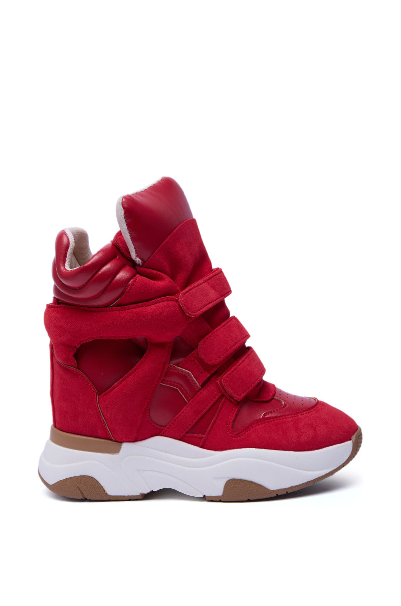 The MARANTO RED WEDGE SNEAKER features multiple velcro straps, side cut-out details, a thick white and brown flatform sole, padded ankle support, and faux leather construction—all showcased against a white background.