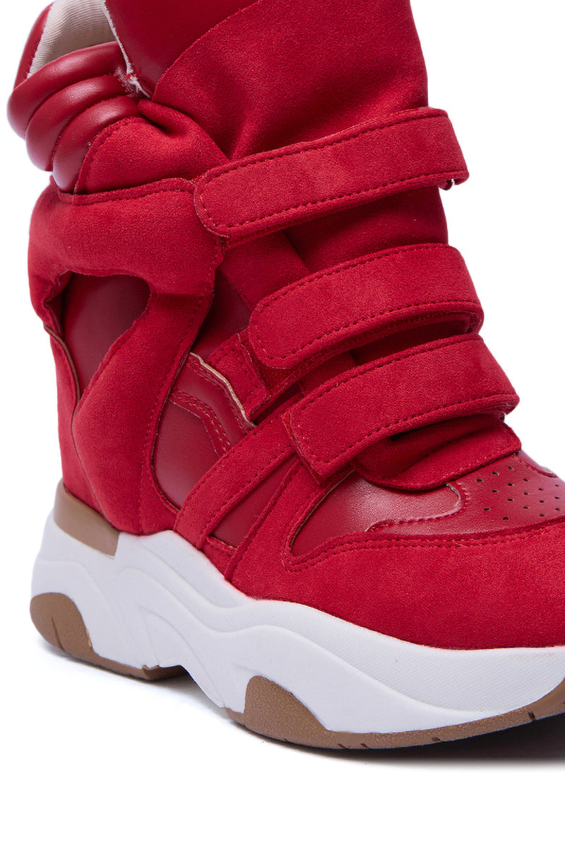 Close-up of the MARANTO RED WEDGE SNEAKER, featuring three velcro straps, a chunky white and tan flatform sole, padded ankle support, and a stylish mix of suede and smooth materials.