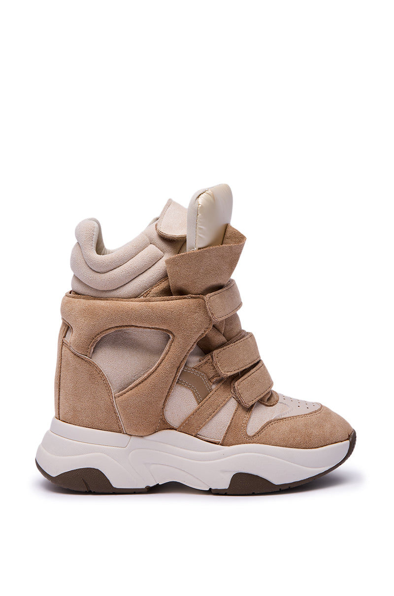 The MARANTO TAUPE WEDGE SNEAKER is a beige high-top with multiple velcro straps, padded tongue, thick white sole, faux leather and fabric textures, and a concealed wedge heel, shown in profile on a white background.