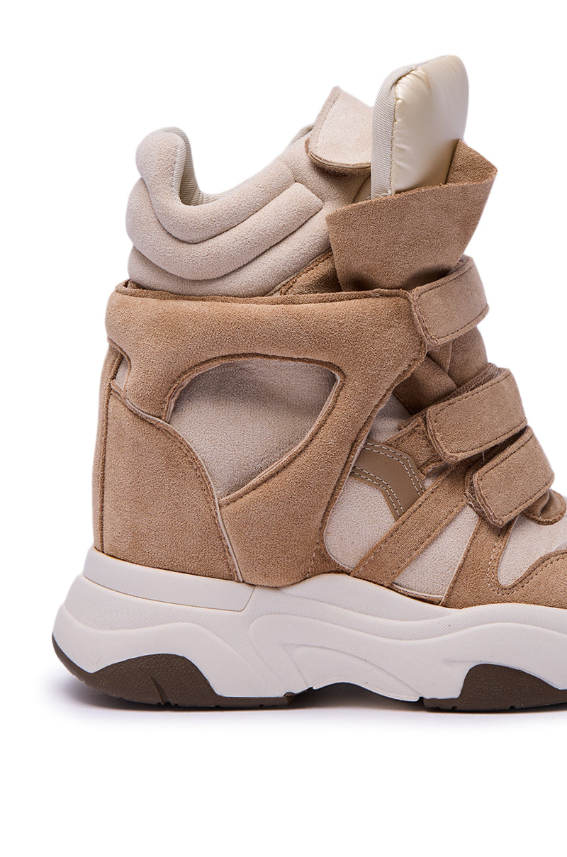 A side view of the MARANTO TAUPE WEDGE SNEAKER shows a high-top in tan and beige suede with thick padding, three velcro straps, a chunky white and brown sole, and a hidden wedge heel, isolated on a white background.