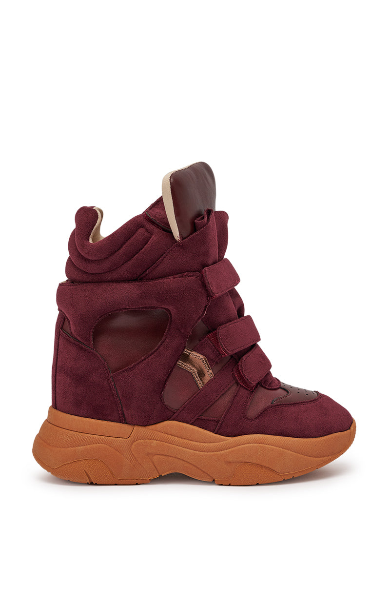 The MARANTO BURGUNDY WEDGE FAUX SUEDE SNEAKER is a maroon high-top with Velcro straps, cut-out details, and a thick tan rubber sole—crafted from faux suede and leather-like materials for a bold streetwear style. 5