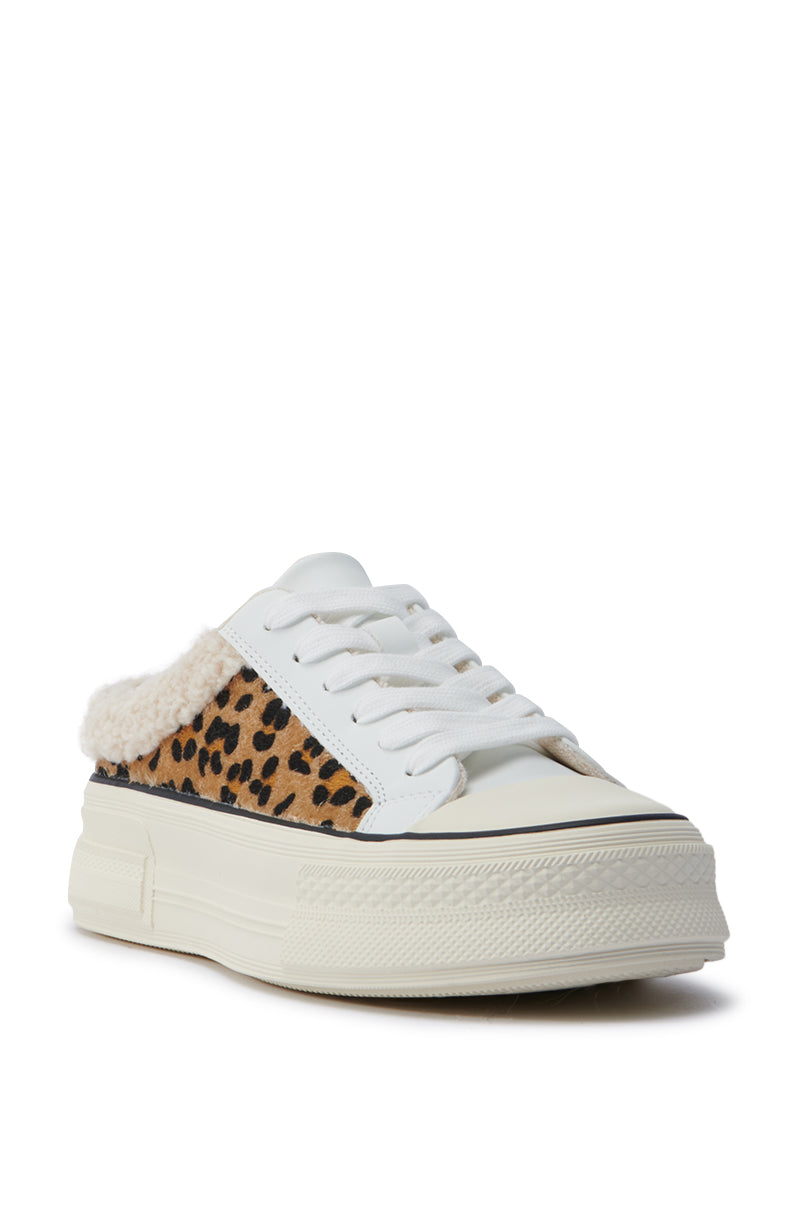 The AZALEA WANG MARGARITA FLAT SNEAKER is a stylish white platform sneaker featuring cheetah print accents on the side and a fluffy lining. This shoe, with its thick sole and white laces, is crafted from faux leather, seamlessly blending chic style with an exotic allure when viewed from an angle.