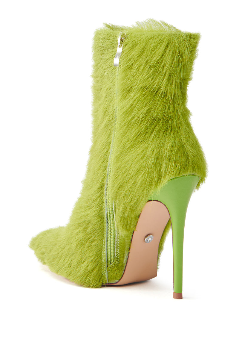The AZALEA WANG MARIELLA green hairy stiletto bootie is an ankle-high, faux-fur shoe with a vibrant green, pointed toe and a side zip. It features a matching slender stiletto heel, with visible sole and heel tip from the side angle.