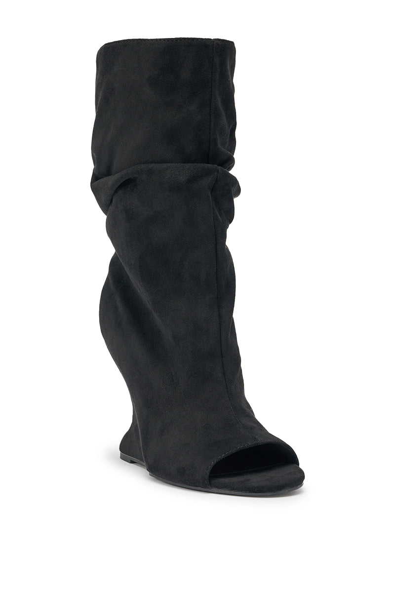 The AZALEA WANG MARIN BLACK FAUX SUEDE WEDGE BOOTIE features a black faux suede finish, slouchy silhouette, wedge heel, and open peep toe, shown at a slight front angle. 5