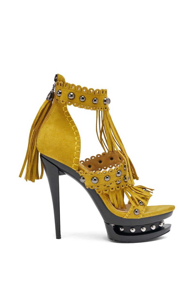 The AKIRA GOLD MAROVA Mustard Sandal is a yellow platform sandal with fringe, embellishments, studded details, a double-platform sole, and a bold black stiletto heel. 3