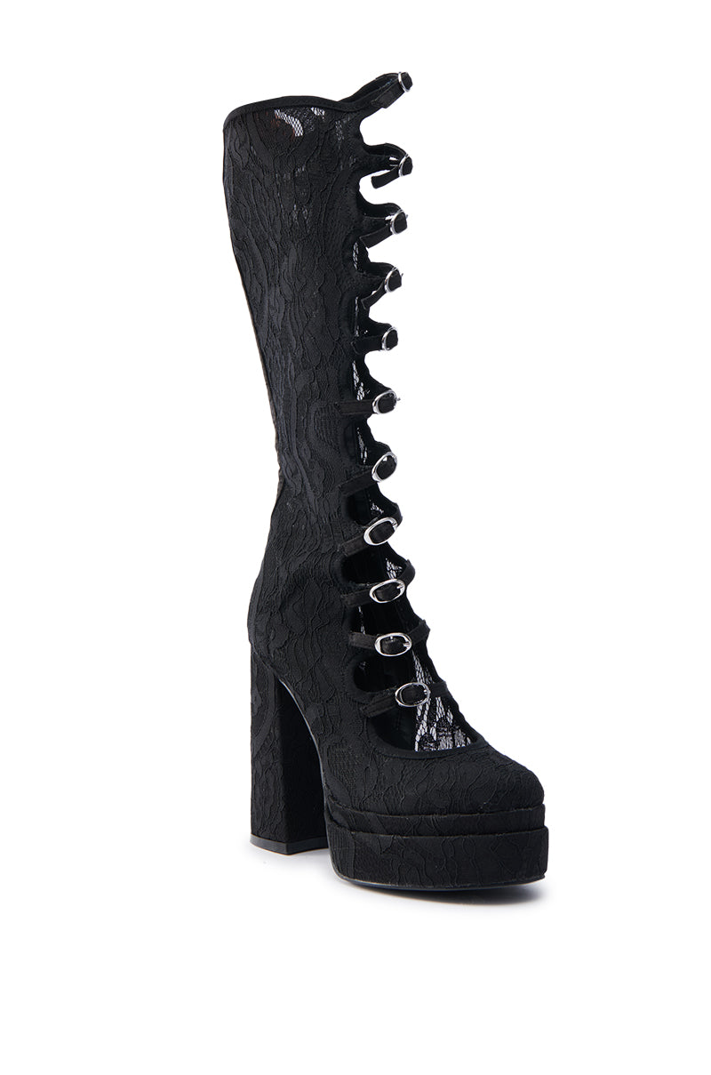The AZALEA WANG MARRIGOLD BOOT IN BLACK LACE is a tall, textured platform boot with decorative silver buckles. It features a chunky heel and extends above the ankle, offering a perfect blend of style and edgy elegance.