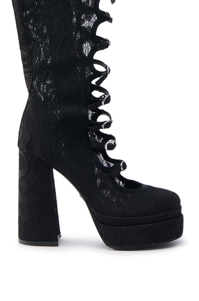 The AZALEA WANG MARRIGOLD BOOT IN BLACK LACE is a bold single high-heeled boot with intricate lace details, a chunky heel, an almond toe, and a unique spiral lace-up front design. Its textured floral pattern adds elegance to this striking footwear style.