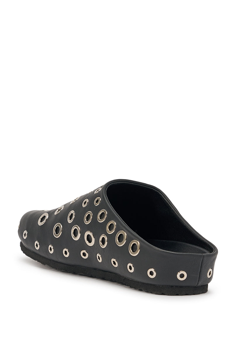 The AZALEA WANG MARSHA BLACK GROMMET DETAIL FLAT is a black slip-on clog with multiple silver grommets of varying sizes on the upper and sides, displayed at an angle against a white background. 5