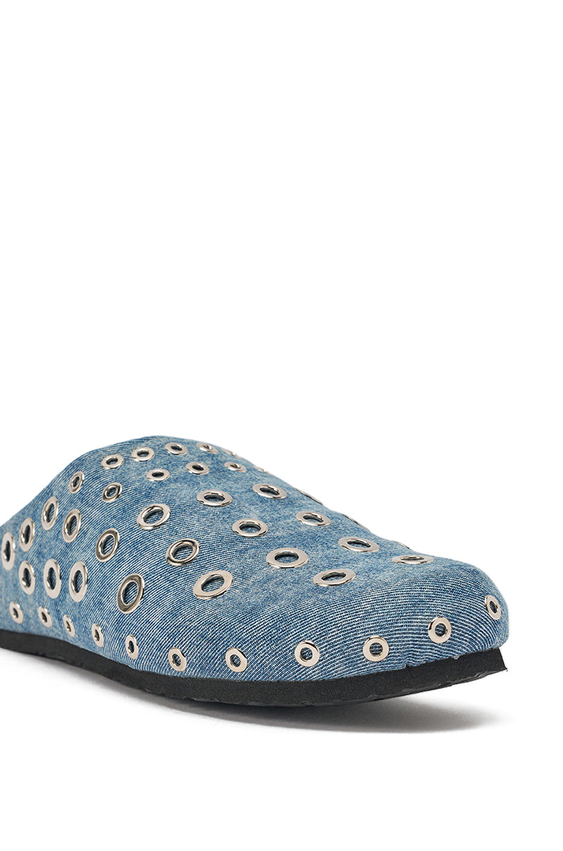 The AZALEA WANG MARSHA DENIM GROMMET DETAIL FLAT is a blue slip-on with a black sole, featuring silver grommets of various sizes across the upper—making it a standout choice for street style. 7