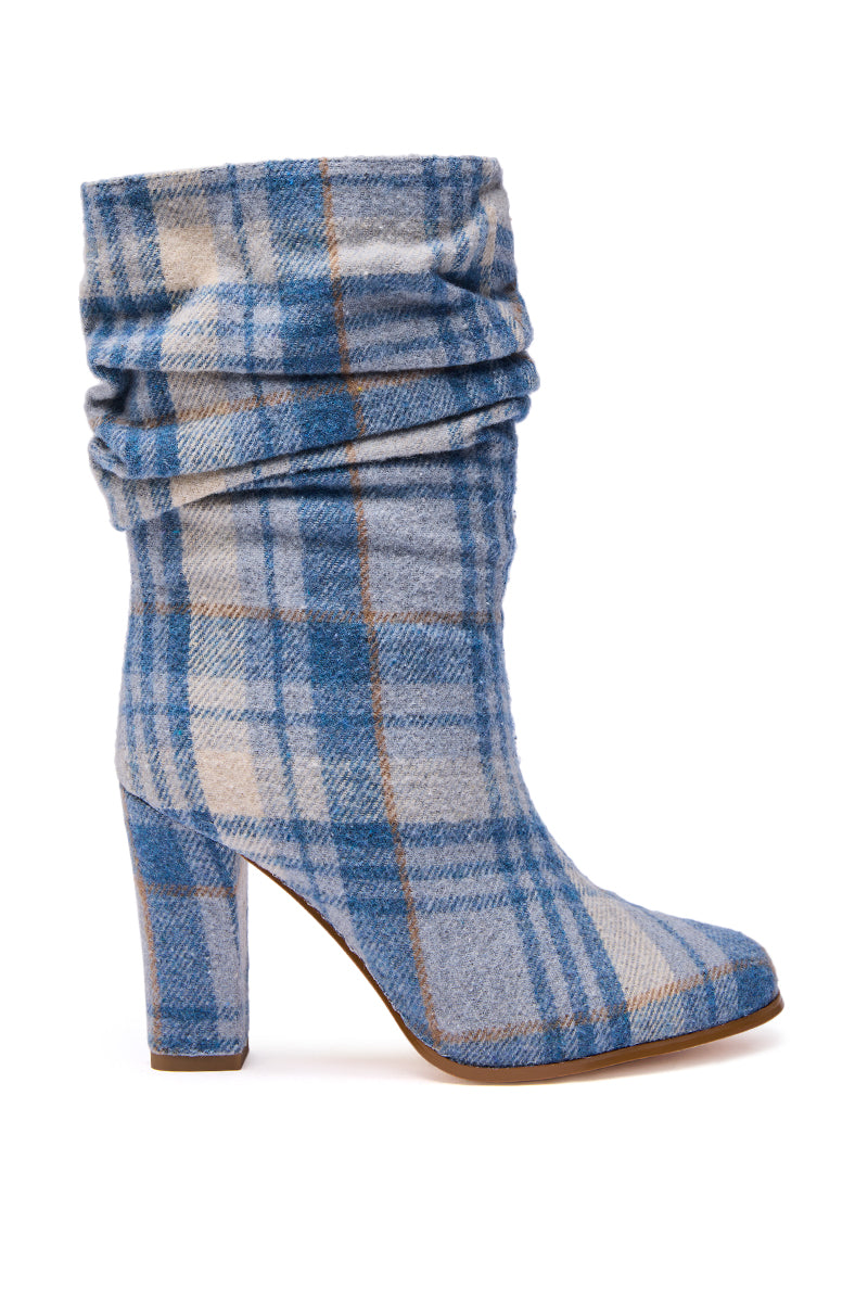 The AZALEA WANG MATHAIS BLUE MULTI PLAID ROUND TOE BOOTIE features a chunky heel, blue, beige, and white plaid fabric, a slouchy ruched ankle design, and a round toe.