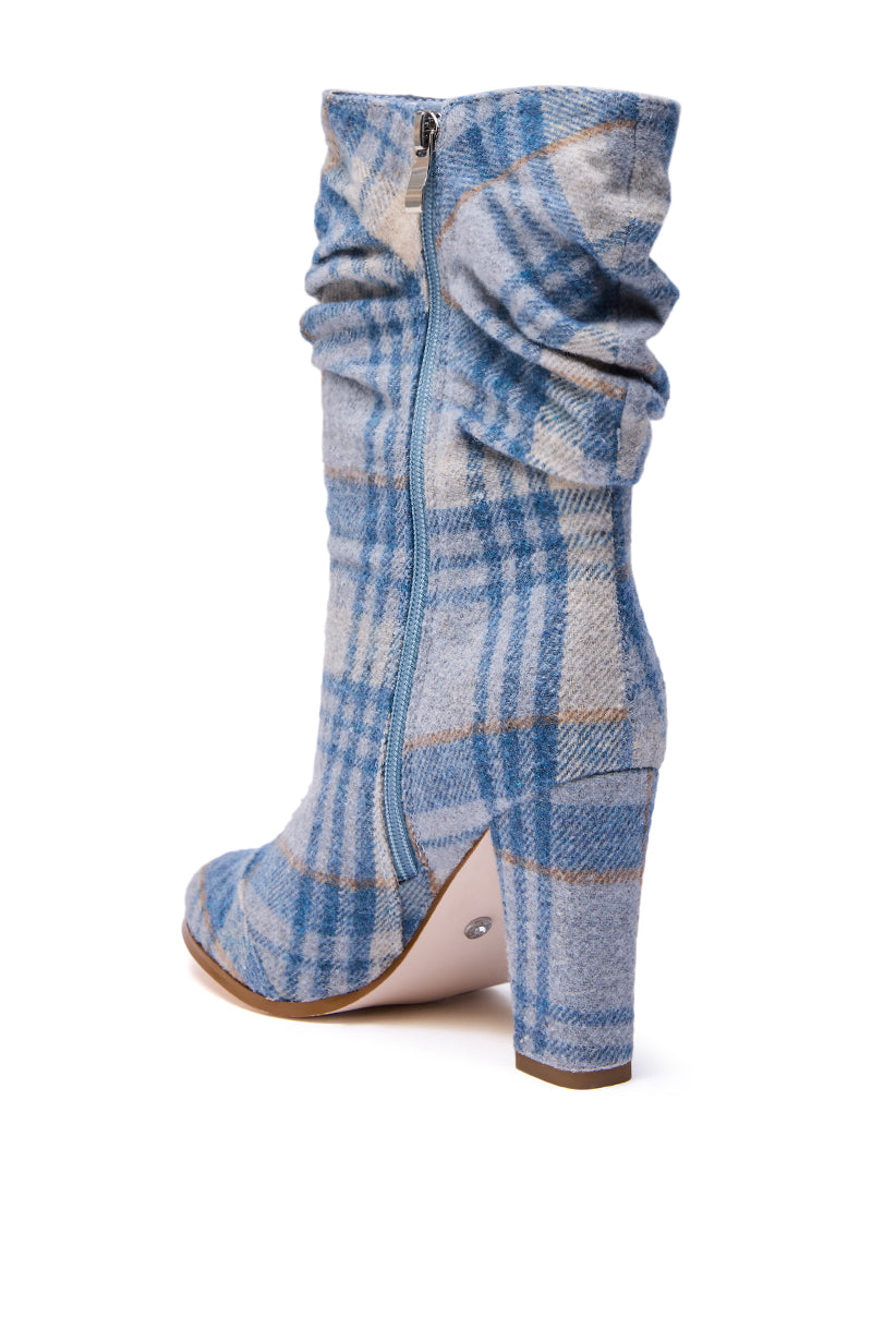The AZALEA WANG MATHAIS BLUE MULTI PLAID ROUND TOE BOOTIE features a blue and beige plaid design, chunky heel, round toe, side zipper, and slightly slouchy shaft, shown on a white background.