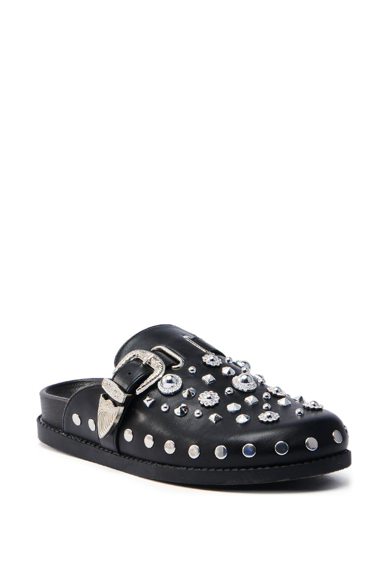 The AZALEA WANG MAULDIN HARDWARE EMBELLISHED CLOG IN BLACK is a vegan leather shoe with silver studs, metal embellishments, an almond toe, and a silver-toned side buckle for a bold style.