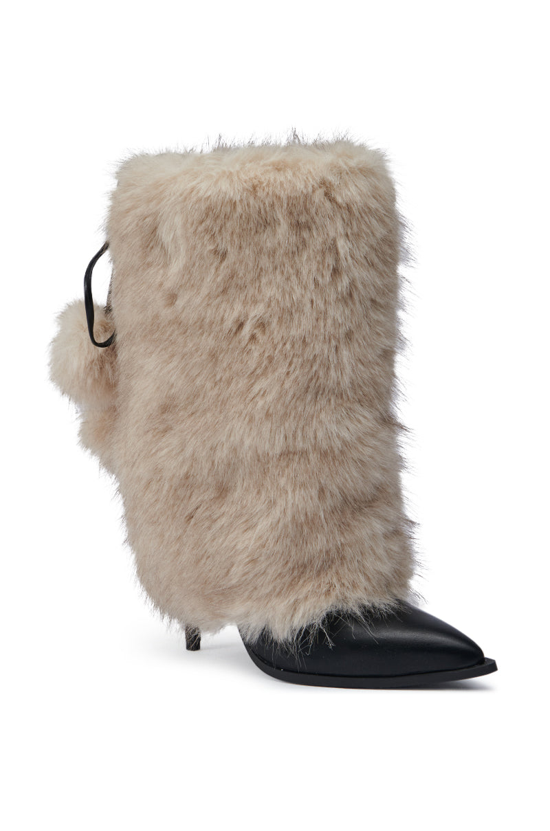 The AZALEA WANG MAYRA TAUPE BOOTIE showcases a stylish faux leather design with a pointed black toe and stiletto heel, wrapped in plush beige fur. A petite black strap adorned with a pom-pom embellishment enhances the side, bringing charm to its mid-calf length.