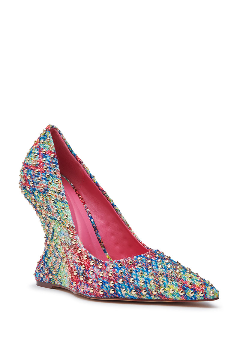 The AZALEA WANG MAYUR MULTI WEDGE PUMP WITH STUD DETAIL features a high wedge heel, multicolored sequins, a sculpted curved heel, pointed toe, bright pink lining, and bold look.