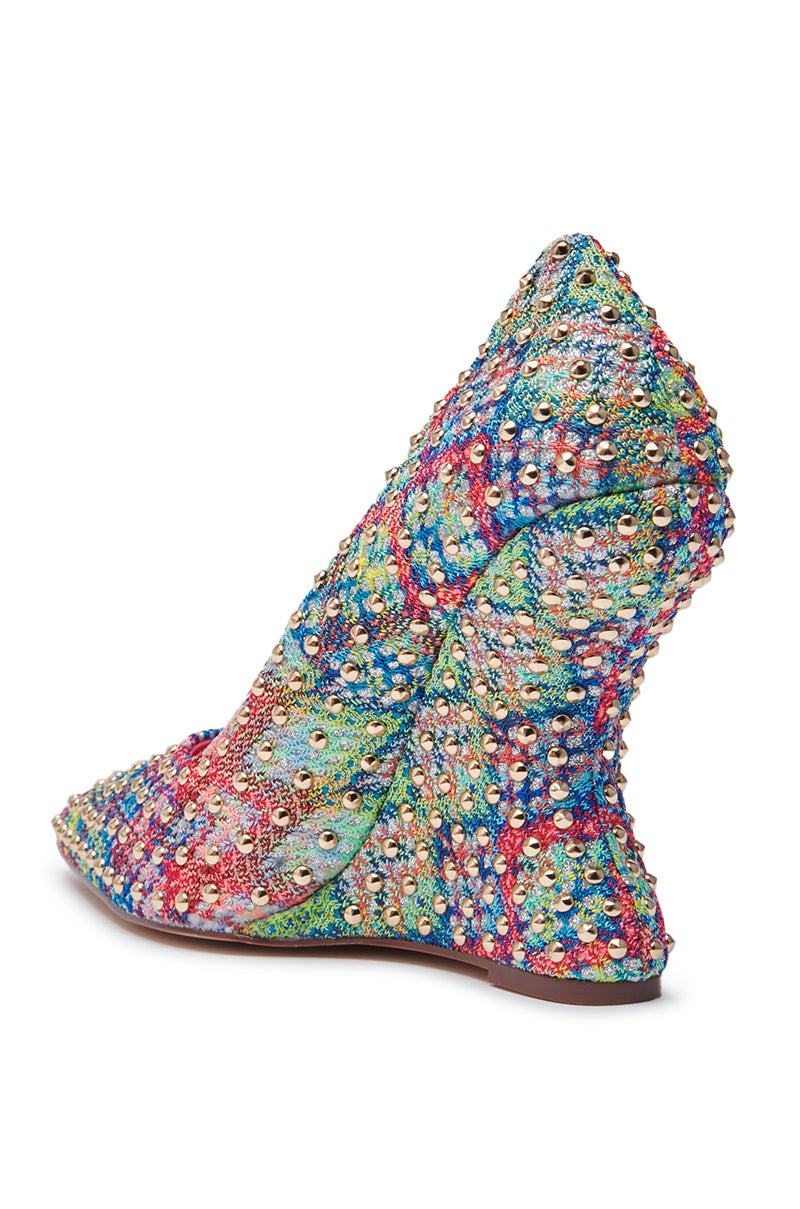The AZALEA WANG MAYUR MULTI WEDGE PUMP features a pointed toe, multicolored sequins and beads, a uniquely sculpted wavy wedge heel, and dazzling stud details on the side and back for extra flair.