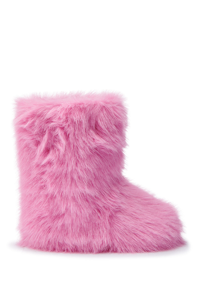 Displayed against a plain white background is the MELANIE PINK FURRY BOOTIE, featuring a cozy sherpa lining and fluffy texture, with a simple, rounded design. 3