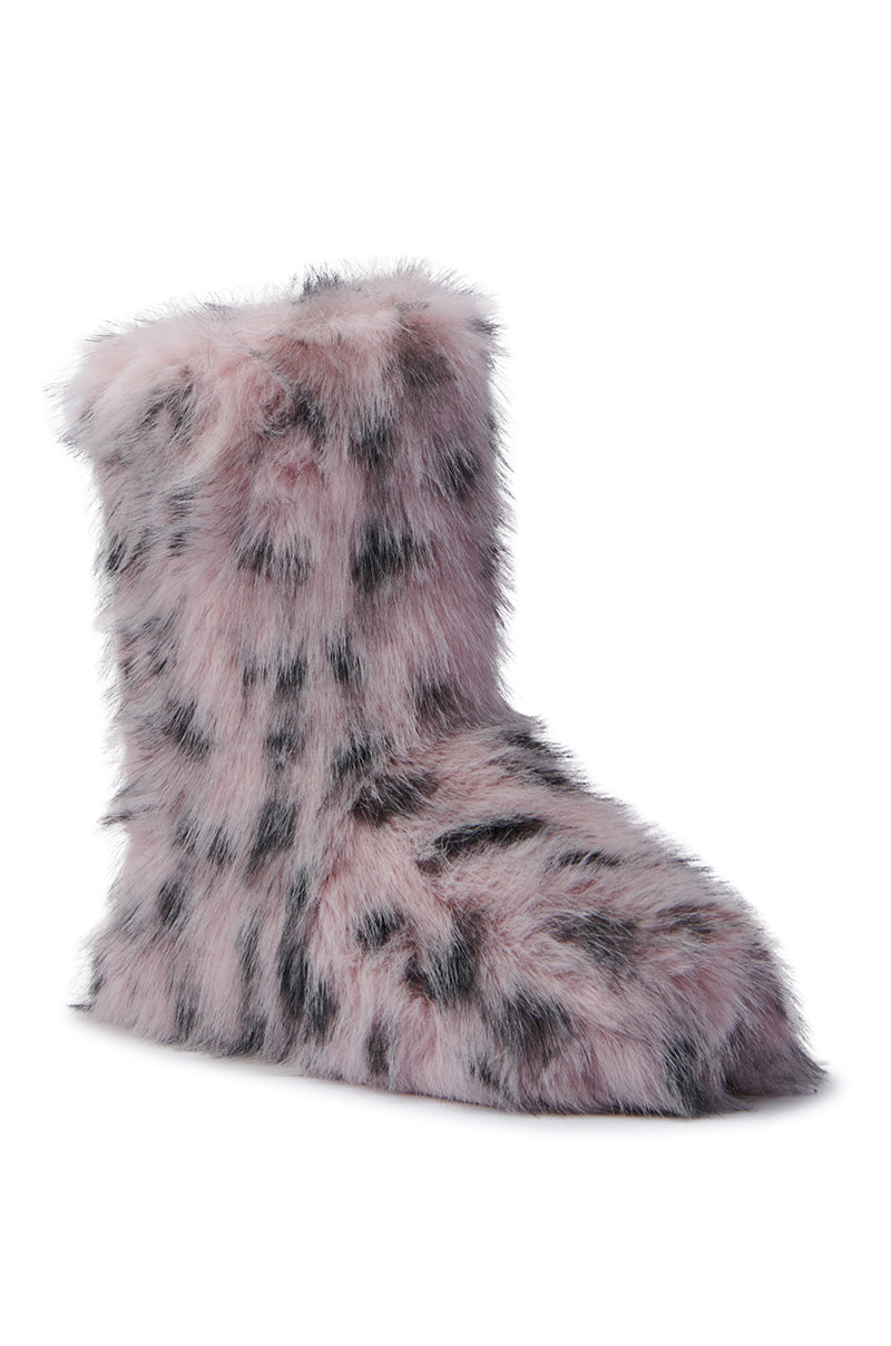 The MELANIE PINK LEOPARD FURRY BOOTIE offers a cozy cold-weather design with its fuzzy single boot style, featuring a light pink base adorned with black leopard-like spots. Made from faux fur, it provides both warmth and comfort against a white background, making it ideal for snug days.