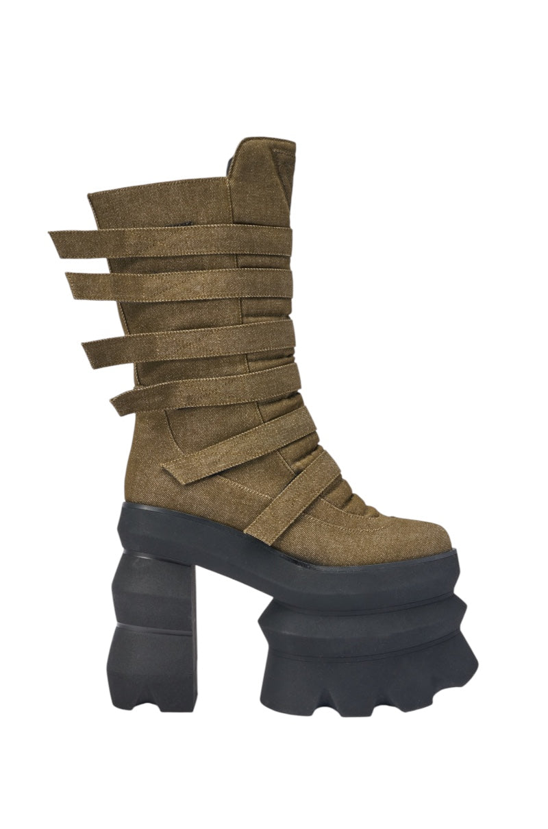 The AKIRA GOLD MENACING OLIVE BLOCK PLATFORM BOOTIE features a chunky olive-green design with multiple horizontal straps around the shaft and a bold black multi-layered geometric platform sole. 3