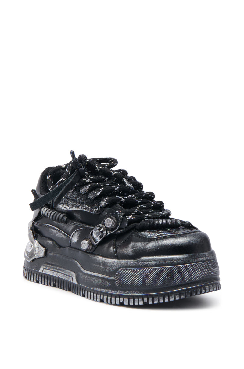 The KOI FOOTWEAR METAMORPHOSIS Black Flat Distressed Sneaker features thick textured laces, a rugged sole, and layered upper details, delivering bold industrial streetwear style with a futuristic edge. 3