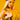 A person with long blonde hair and visible torso tattoos poses confidently against a bright yellow background, wearing a neon green bikini top, gold bangles, a CHEETAH ANIMAL HEAD SCARF hair accessory, and holding a matching purse.