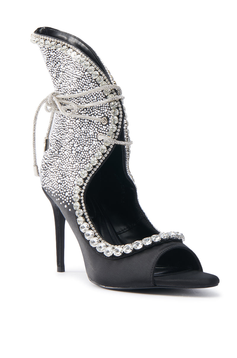 The AZALEA WANG MICAELA BLACK SILVER RHINESTONE OPEN TOE LACE UP STILETTO BOOTIE features silver rhinestones, a decorative silver cord lacing around the ankle, and a unique cutout design with a slim stiletto heel for an elegant touch, set against a plain white background.