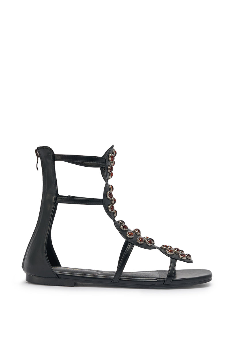 The AZALEA WANG MIKAERE is a black and brown faux leather flat strap sandal featuring stone embellishments. 4