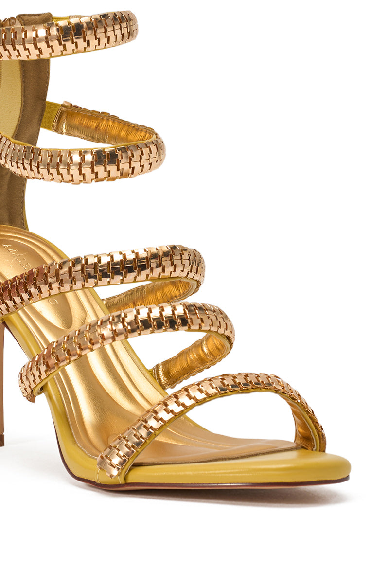 A close-up of the AZALEA WANG MILA Citron Yellow sandal, featuring gold hardware, embellished strappy faux leather with a shiny finish, and an open toe stiletto design wrapping around the foot and ankle. 7