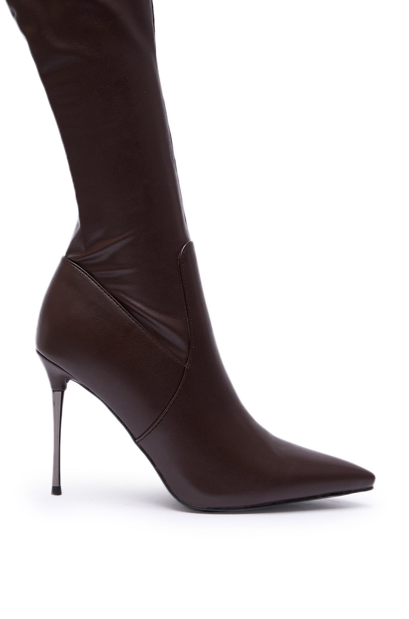 The AZALEA WANG MILANDRA CHOCOLATE THIGH HIGH SEXY BOOT features a sleek, dark brown faux leather finish, pointed toe, and stiletto heel, shown from the side against a white background.