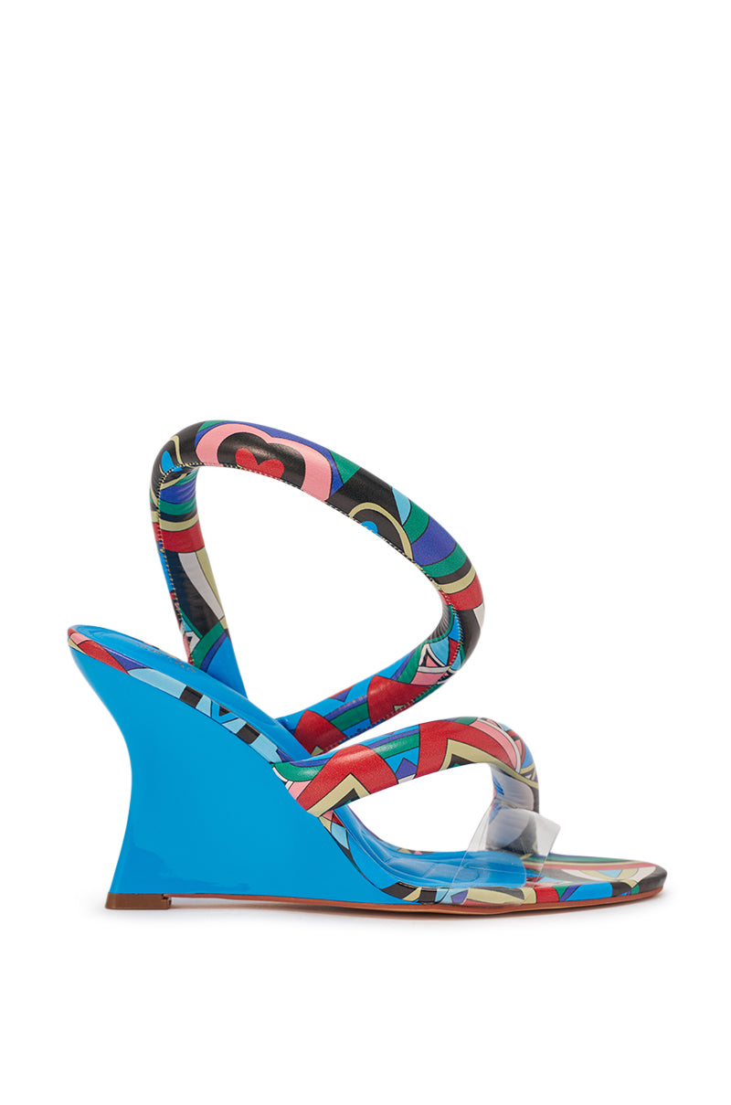 The AKIRA GOLD MINORU MULTI PRINTED WEDGE PUFF SANDAL features a vibrant abstract wedge heel, multicolored patterned straps, a clear toe strap, and matching colorful sole designs. 4