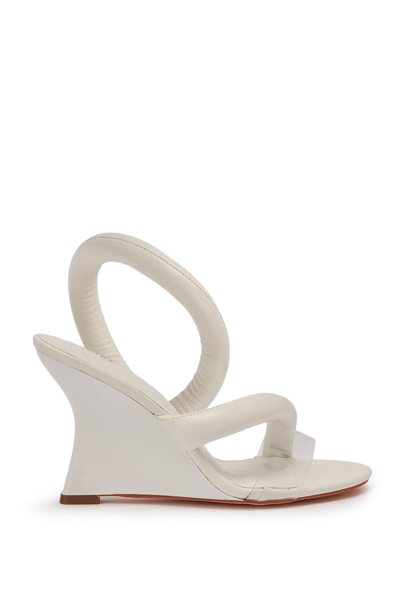The AKIRA MINORU WHITE WEDGE SANDAL is a modern white wedge-heel shoe with a sculptural padded ankle strap, transparent front toe band, comfort cushion insole, and a sleek sole accented by a subtle red-brown edge. 6