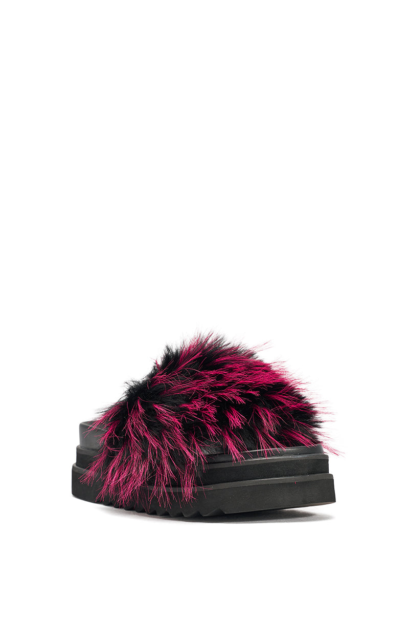 The AKIRA MIRAY PINK MULTI FUR SLIDE is a black faux leather platform sandal with a thick sole and a strap featuring bright pink and black faux fur, photographed on a white background. 5