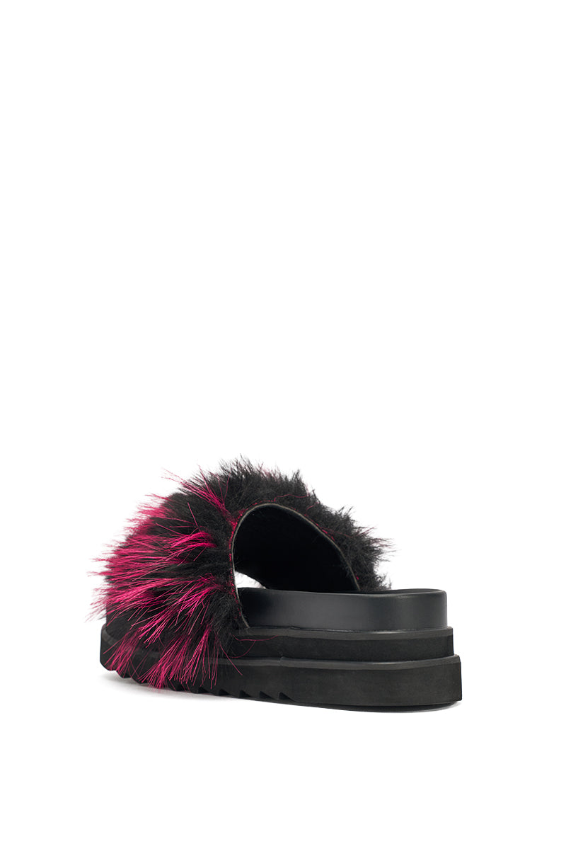 The AKIRA MIRAY PINK MULTI FUR SLIDE is a black faux leather platform sandal with a fluffy strap decorated in black and bright pink faux fur, shown from a rear side angle on a white background. 6