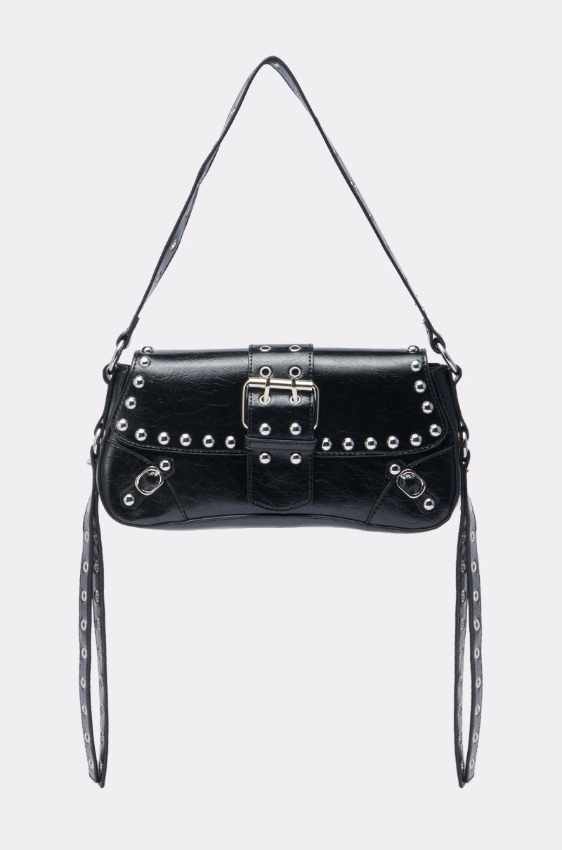 The JORDY STUD PURSE is a moto-inspired black leather handbag with silver studs, hardware, a buckle closure, short shoulder strap, and two long decorative straps for a sleek, edgy look. 1