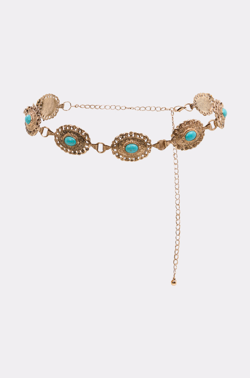 The WITH IT CHAIN BELT features oval engraved gold medallions set with turquoise stones, linked together with an adjustable clasp—making it the perfect Western accessory for your next music festival.