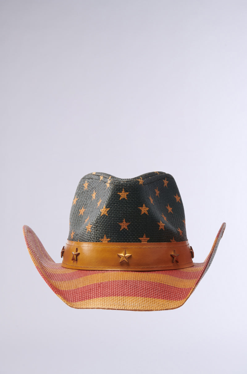 The AMERICAN DREAM COWBOY HAT features a black crown with gold stars, a brown leather band with star studs, and a brim accented by red and tan stripes, capturing the patriotic spirit against a light background.