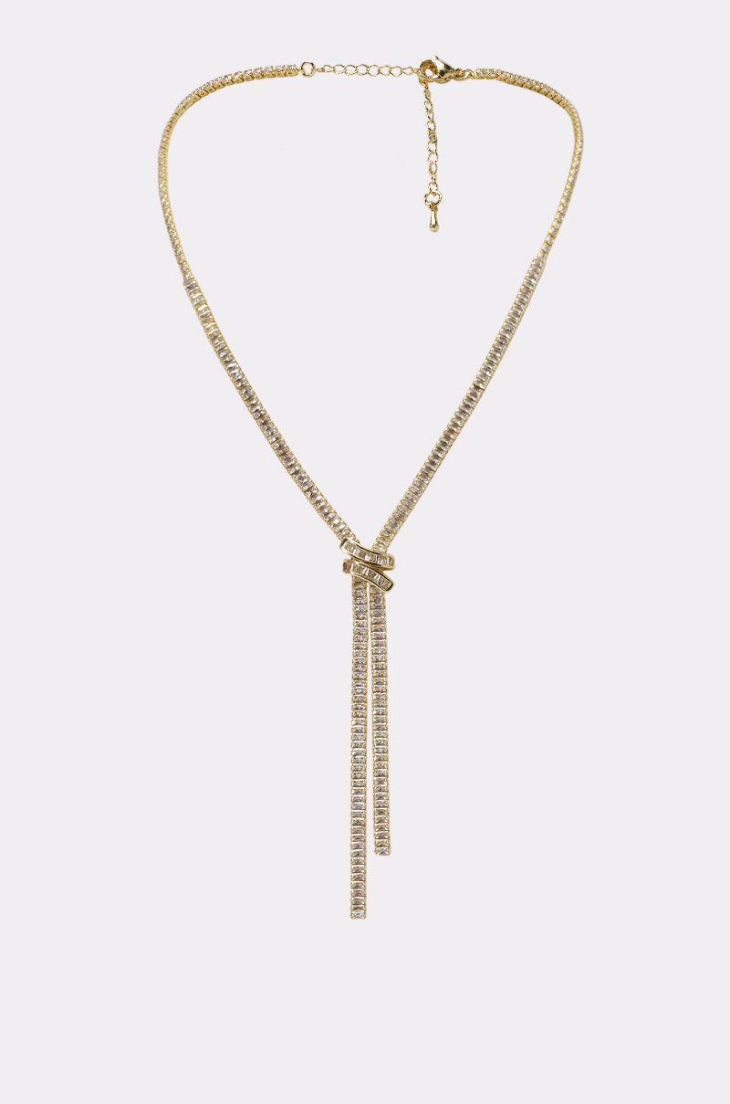 The SO SEXY NECKLACE is a gold rhinestone Y-shaped necklace with two dangling crystal-encrusted strands and an adjustable chain clasp—ideal for luxe accessorizing.