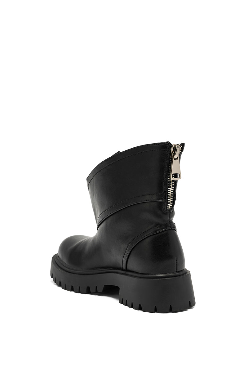 The AZALEA WANG MOHSEN BLACK COMBAT BOOTIE is a black faux leather ankle boot with a chunky rubber sole and visible silver back zipper, shown angled from the rear against a plain white background.