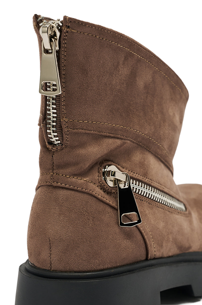 Close-up of the AZALEA WANG MOHSEN MOCHA COMBAT BOOTIE in brown faux suede, featuring two shiny silver zippers—one at the back, one on the side—and a thick black sole. Detailed stitching and texture show off its stylish combat design.