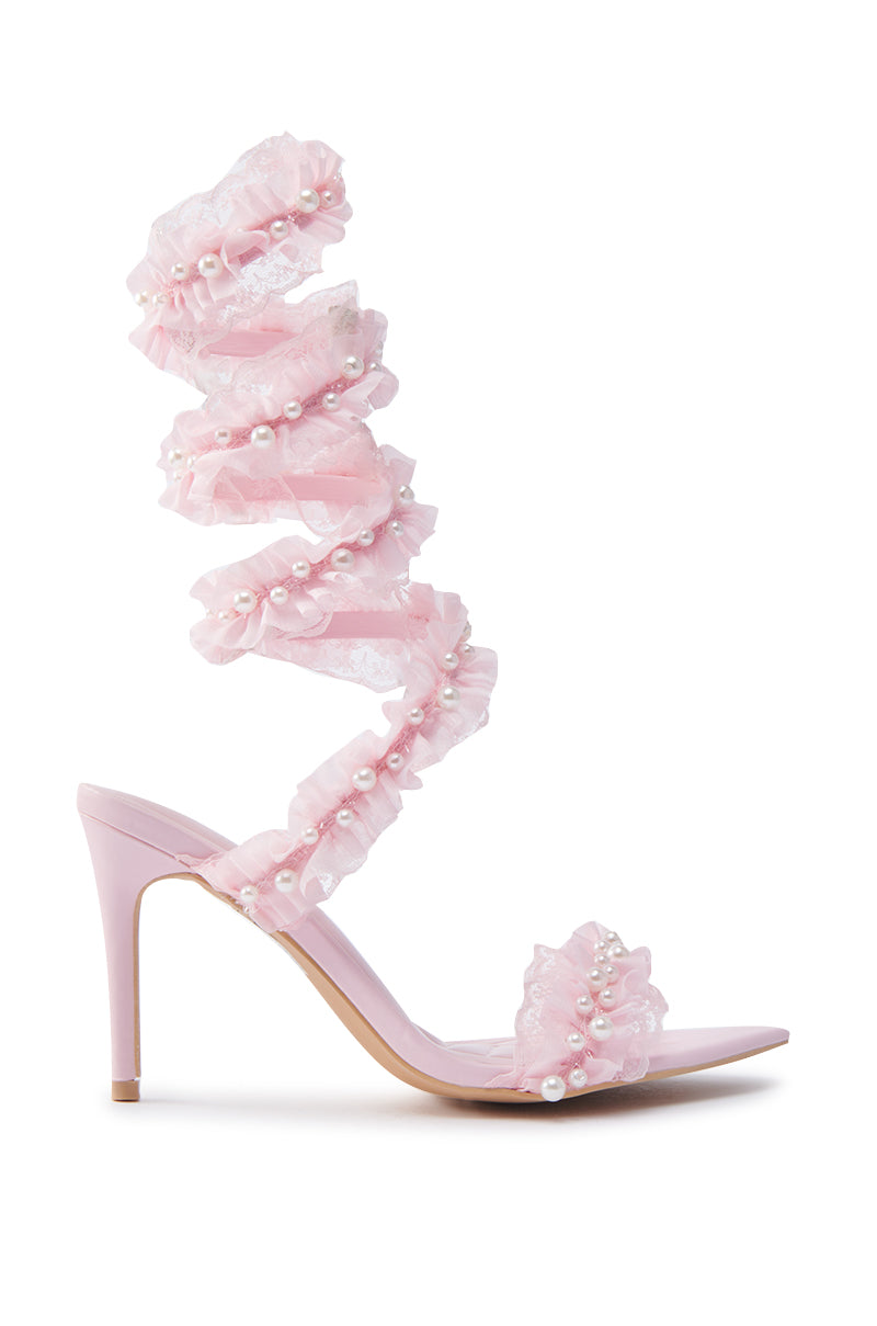 The AZALEA WANG Morine Pink Spiral Stiletto Sandal showcases a single shoe with a ruffled, pearl-adorned spiraling ankle strap, an open toe design, and a smooth glossy finish.