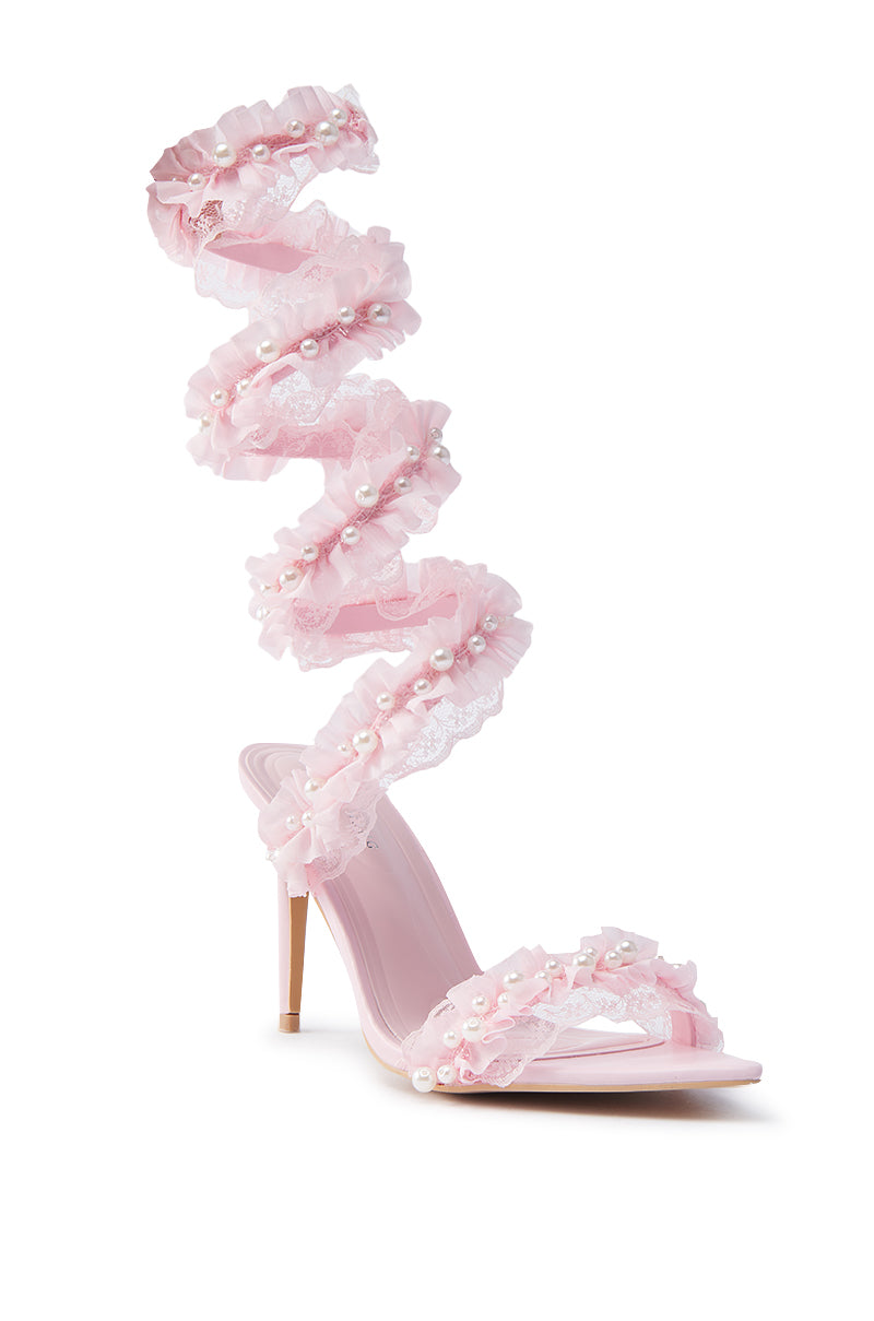 The AZALEA WANG MORINE PINK WITH PEARLS SPIRAL STILETTO SANDAL features a spiraling lace strap with pearl beads extending above the ankle, along with a thin heel and open-toe design.