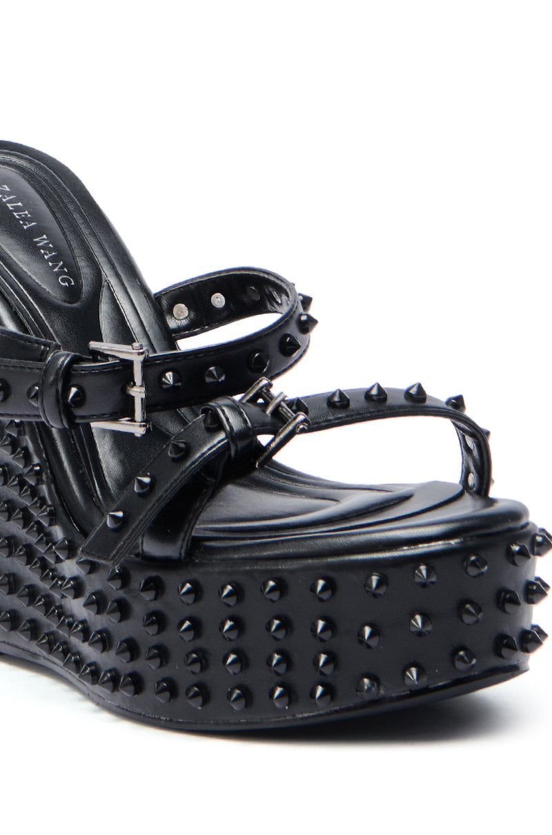 The AZALEA WANG MORITZ Black Spikey Wedge Sandal features multiple straps with silver buckles, bold black studs for a punk-glam vibe, and a thick platform sole.